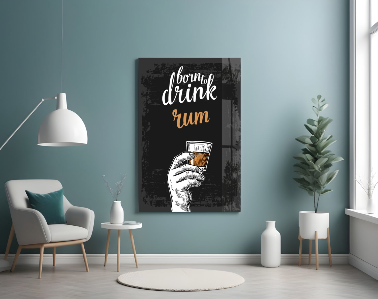 Black wooden rum wall art with white and gold hand-holding-glass illustration displayed in turquoise room with chair and plants.