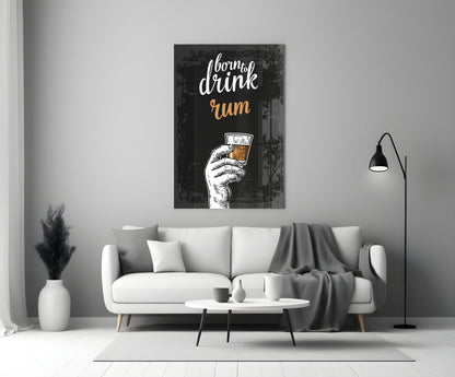 Black canvas rum wall art displaying white script text and illustrated hand holding amber drink, hanging above white sofa in modern living room.