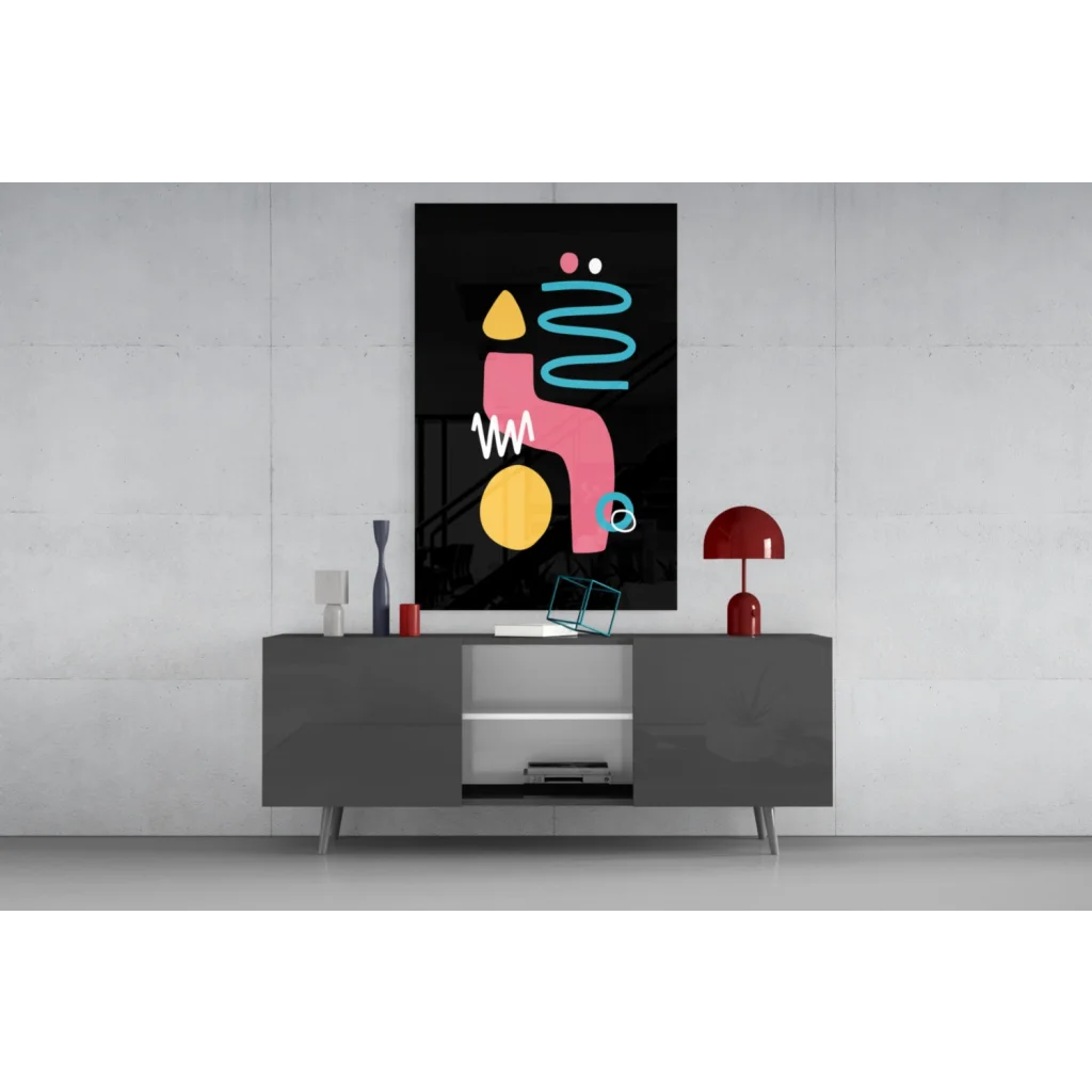 Vibrant glass wall art with pink, yellow, teal geometric shapes on black
