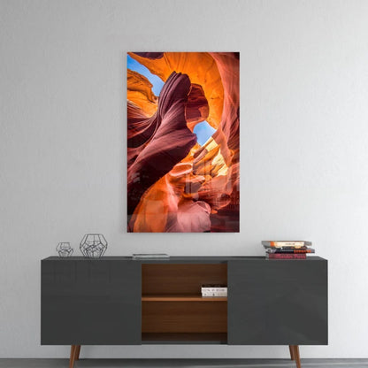 Vibrant orange red glass wall art of canyon above gray console