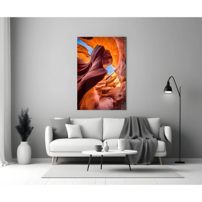 Fiery orange red glass wall art of canyon above white sofa