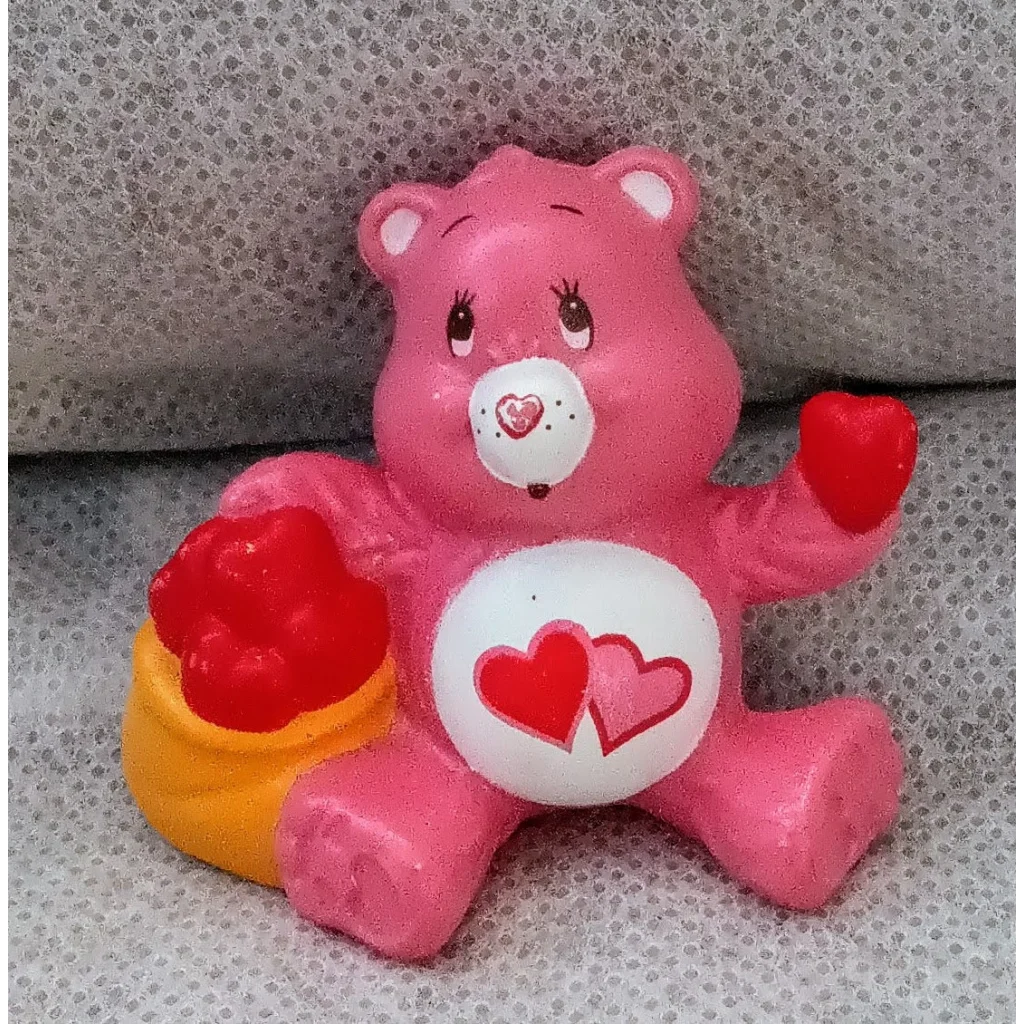 Cute pink Love-A-Lot Care Bears mini figure with hearts and yellow bucket