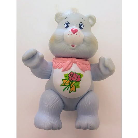 Cute Care Bears PVC figure with pink bow and floral belly design