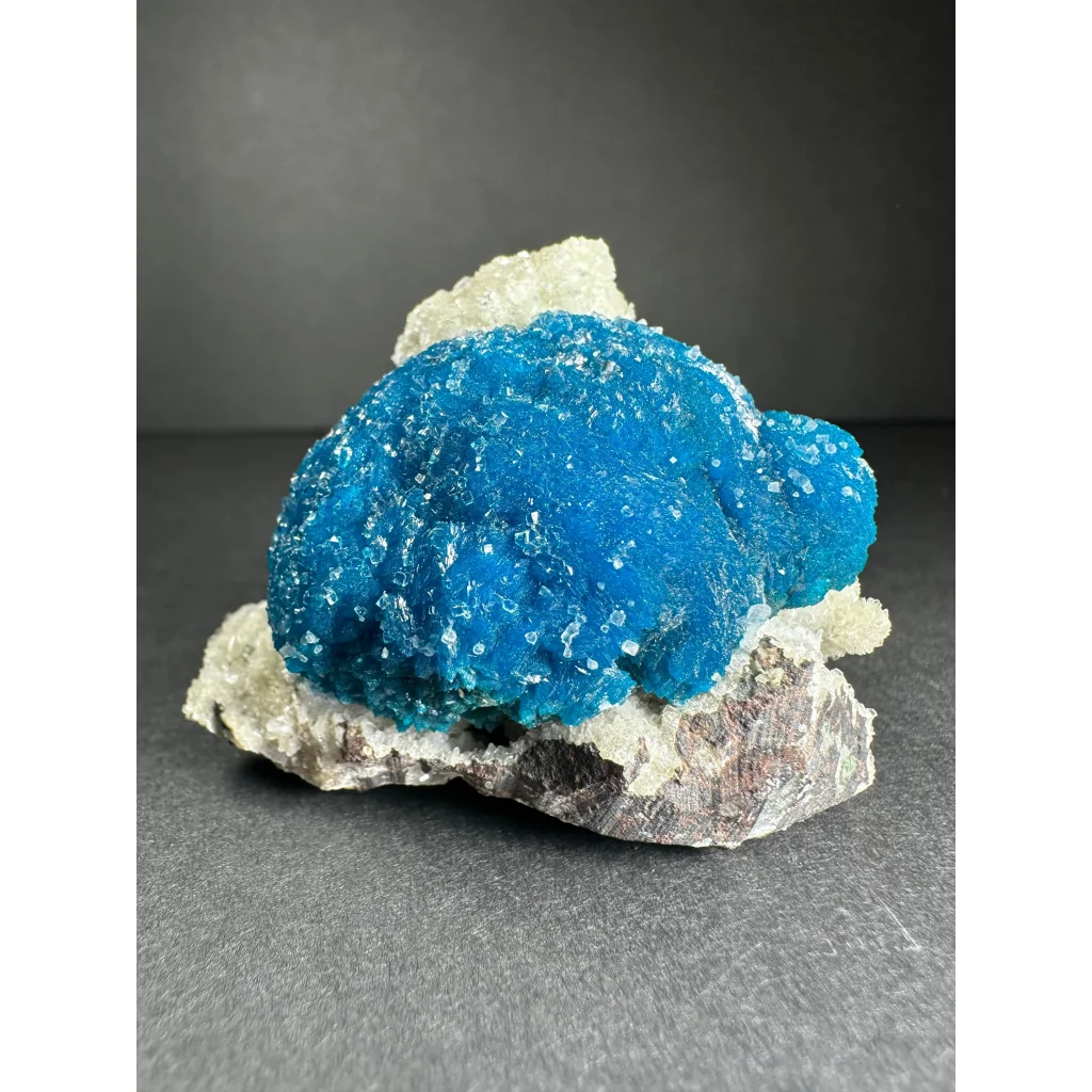 Vibrant blue cavansite with stilbite crystals on gray matrix from Pune, India