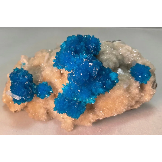 Vibrant blue cavansite and stilbite crystals on matrix from Pune, India
