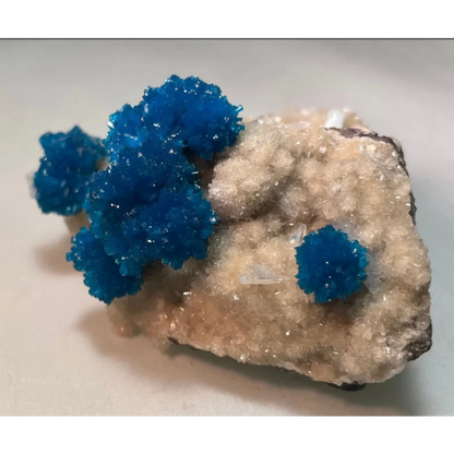 Vibrant blue cavansite and stilbite crystals on quartz matrix from Pune, India