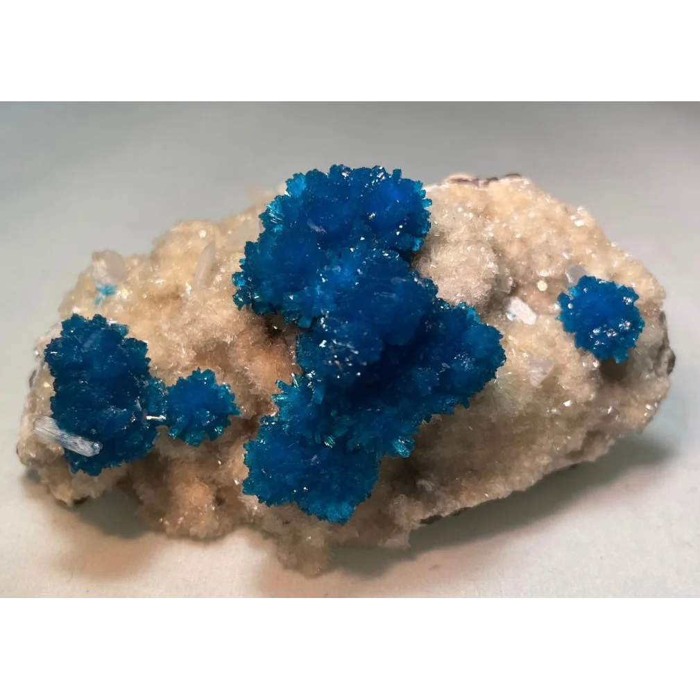 Vibrant blue cavansite and stilbite crystals on matrix from Pune, India