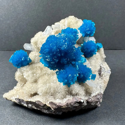 Vibrant blue cavansite and stilbite crystals on matrix from Pune, India