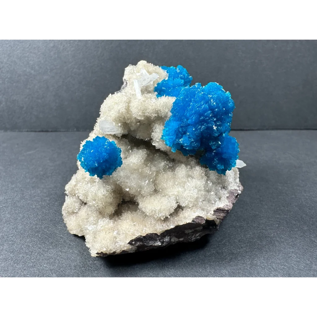 Vibrant blue cavansite and stilbite crystals on quartz matrix from Pune, India
