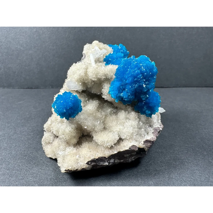 Vibrant blue cavansite and stilbite crystals on quartz matrix from Pune, India