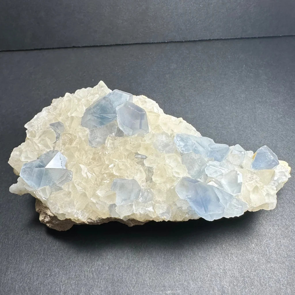 Translucent blue and white celestite crystals with calcite specimen