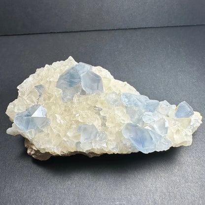 Translucent blue and white celestite crystals with calcite specimen