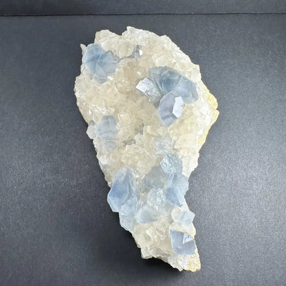 Vibrant celestite crystals cluster with blue fluorite and jagged calcite
