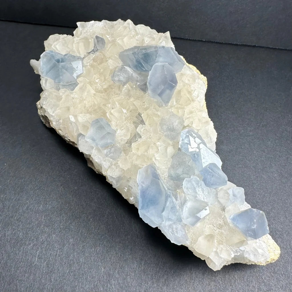 Translucent blue celestite crystals with dogtooth calcite specimen