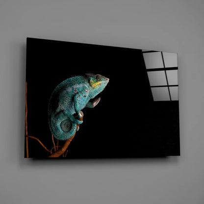 Vibrant teal chameleon on branch in black-and-white glass wall art