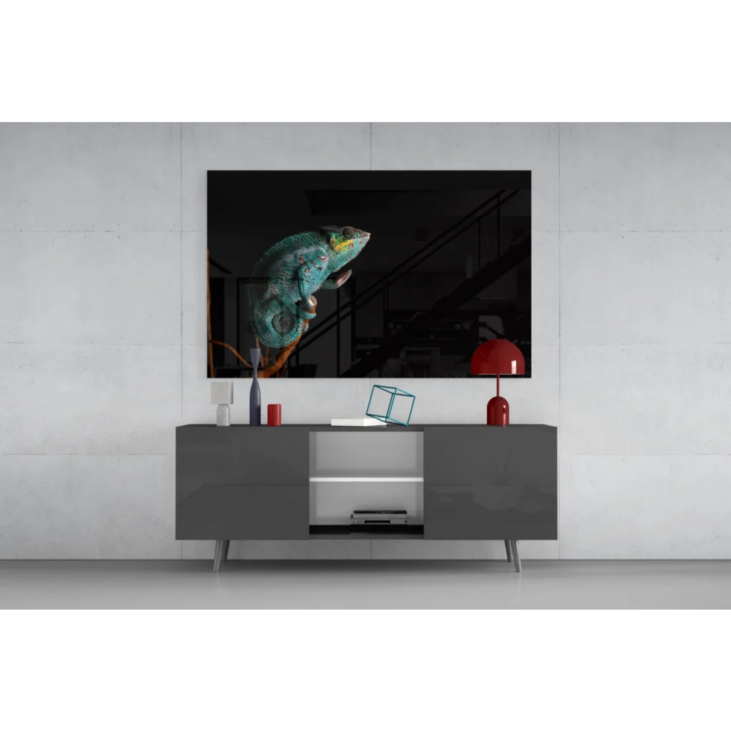 Vibrant teal chameleon glass wall art on black canvas