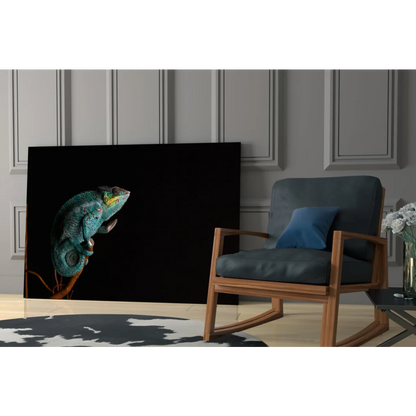 Vibrant teal chameleon glass wall art on black canvas