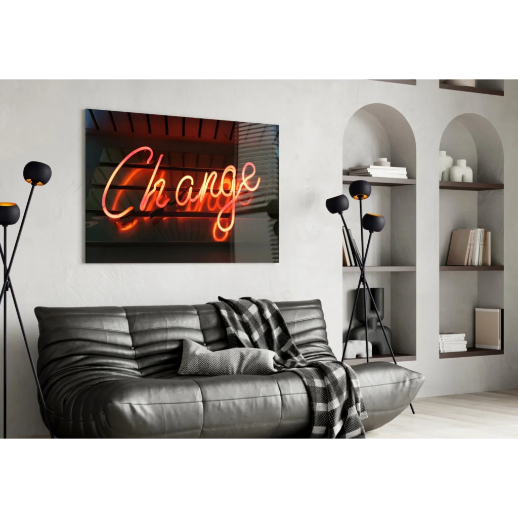 Glowing orange neon change sign in cursive on glass wall art