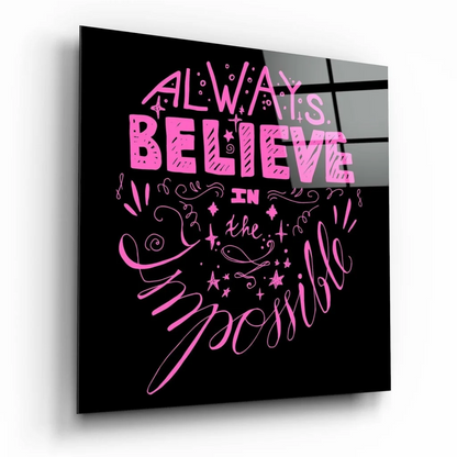 Glossy black glass wall art with pink believe in the impossible text and glitter stars