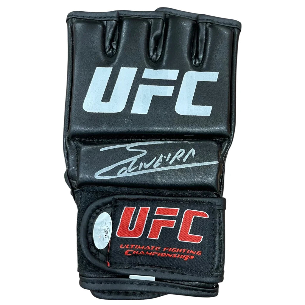 Black ufc mma glove with white and red branding featuring charles oliveira autographed signature on the backhand