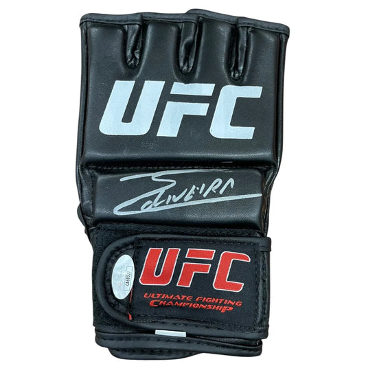 Black ufc mma glove with white and red branding featuring charles oliveira autographed signature on the backhand