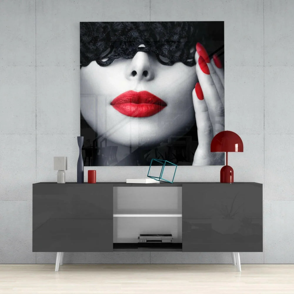 Striking black-and-white glass wall art of woman with bold red lips and lace eye mask