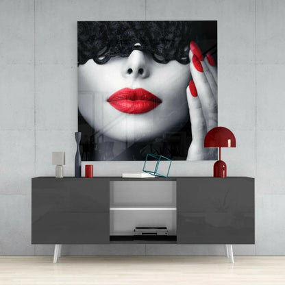 Striking black-and-white glass wall art of woman with bold red lips and lace eye mask