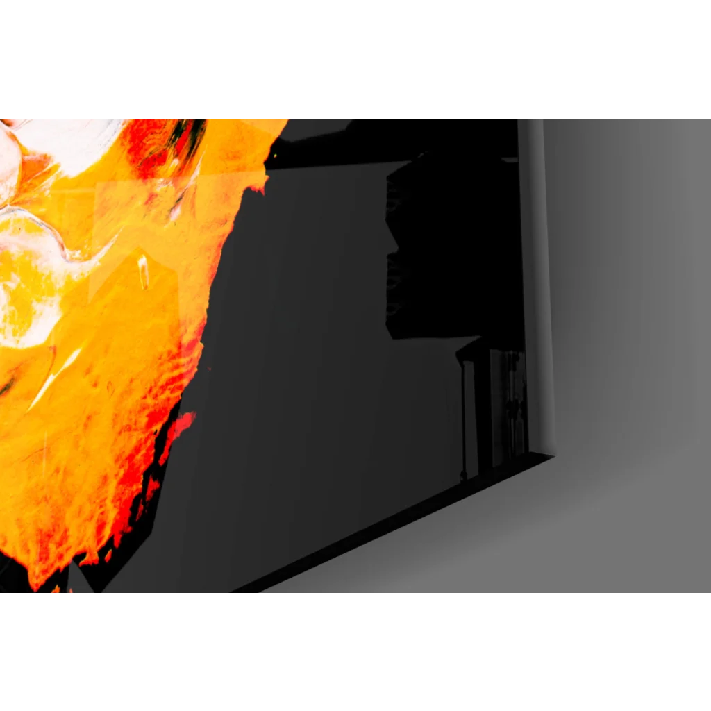 Fiery orange and yellow abstract glass wall art on sleek black monitor