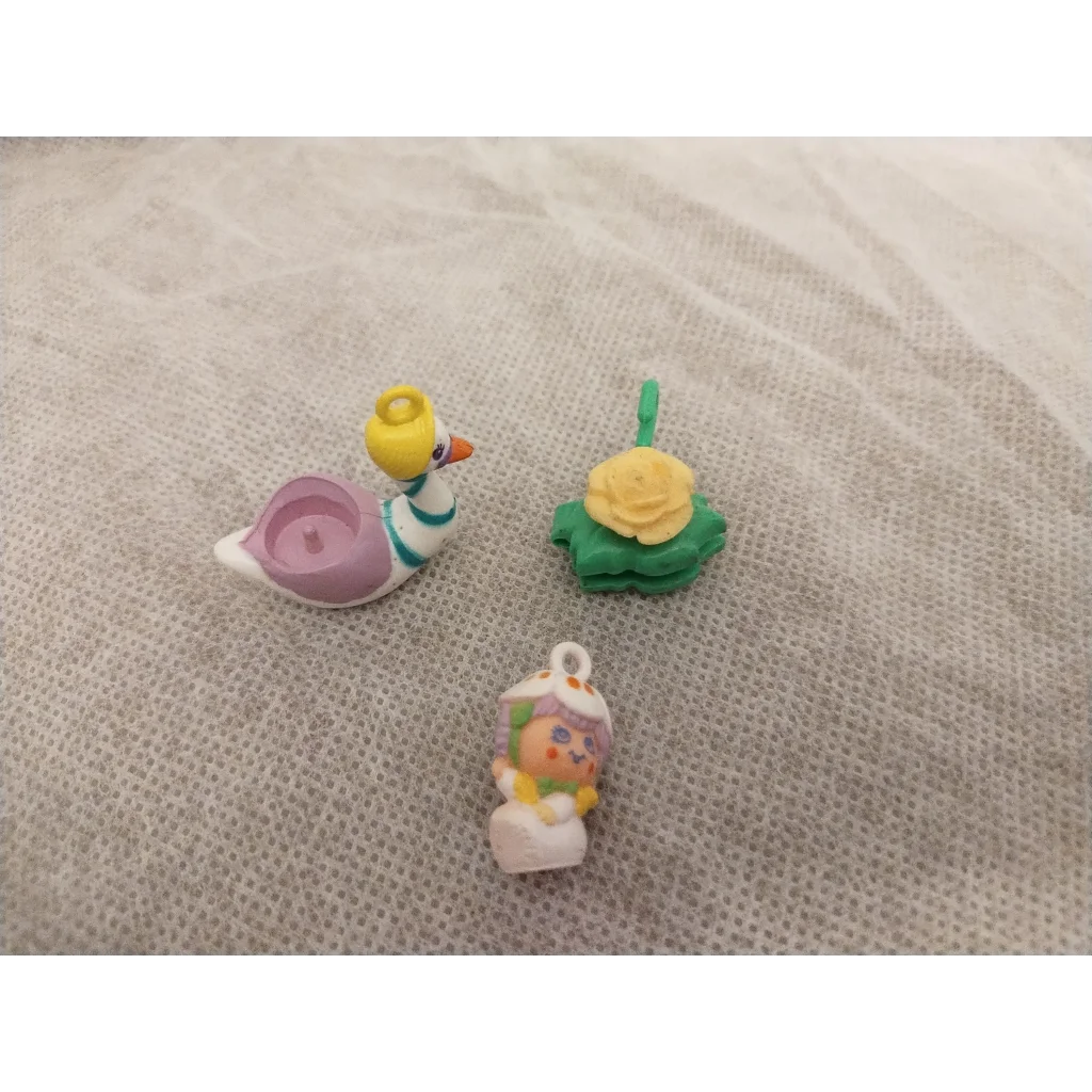 Vintage 1983 Hasbro Charmkins Twinkie Duck keychain with white body and yellow beak