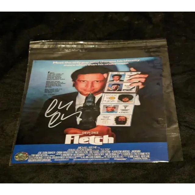 Autographed Fletch movie poster in plastic sleeve with certificate of authenticity