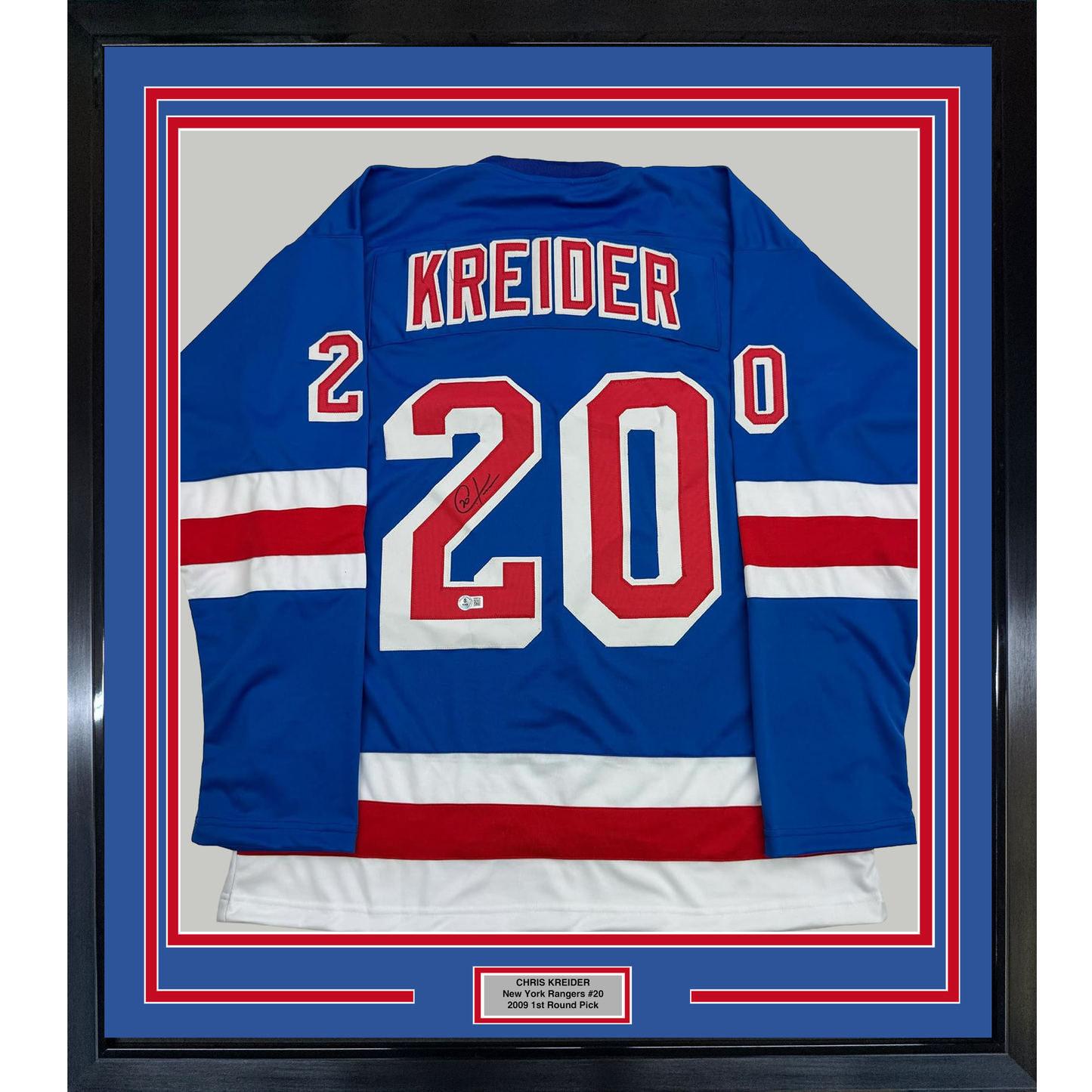 Framed blue New York Rangers hockey jersey #20 with "KREIDER" and number visible, displayed front-facing in black frame with red and blue matting.