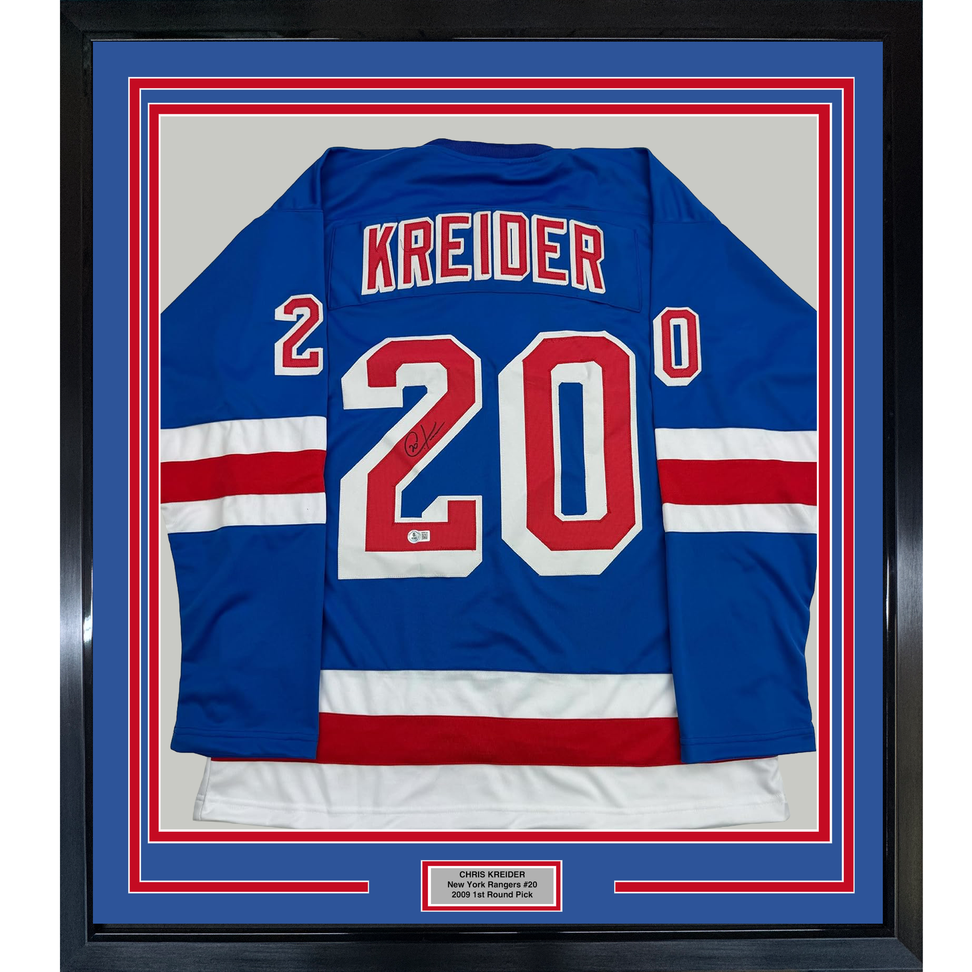 Framed blue New York Rangers hockey jersey #20 with "KREIDER" and number visible, displayed front-facing in black frame with red and blue matting.