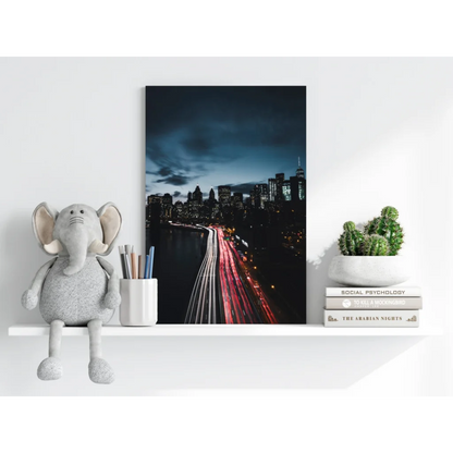 Sleek insigne aluminum print of black-and-white cityscape with red light trails over river at night