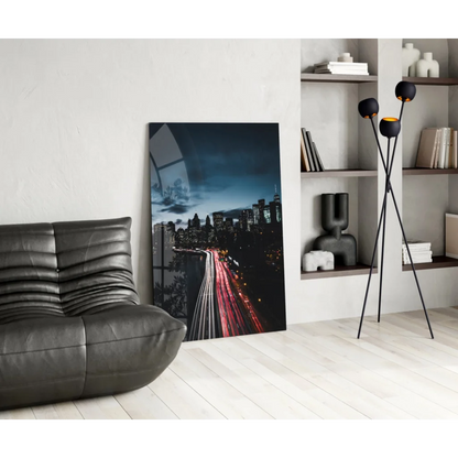 Stunning glass wall art of glowing city lights on black leather sofa