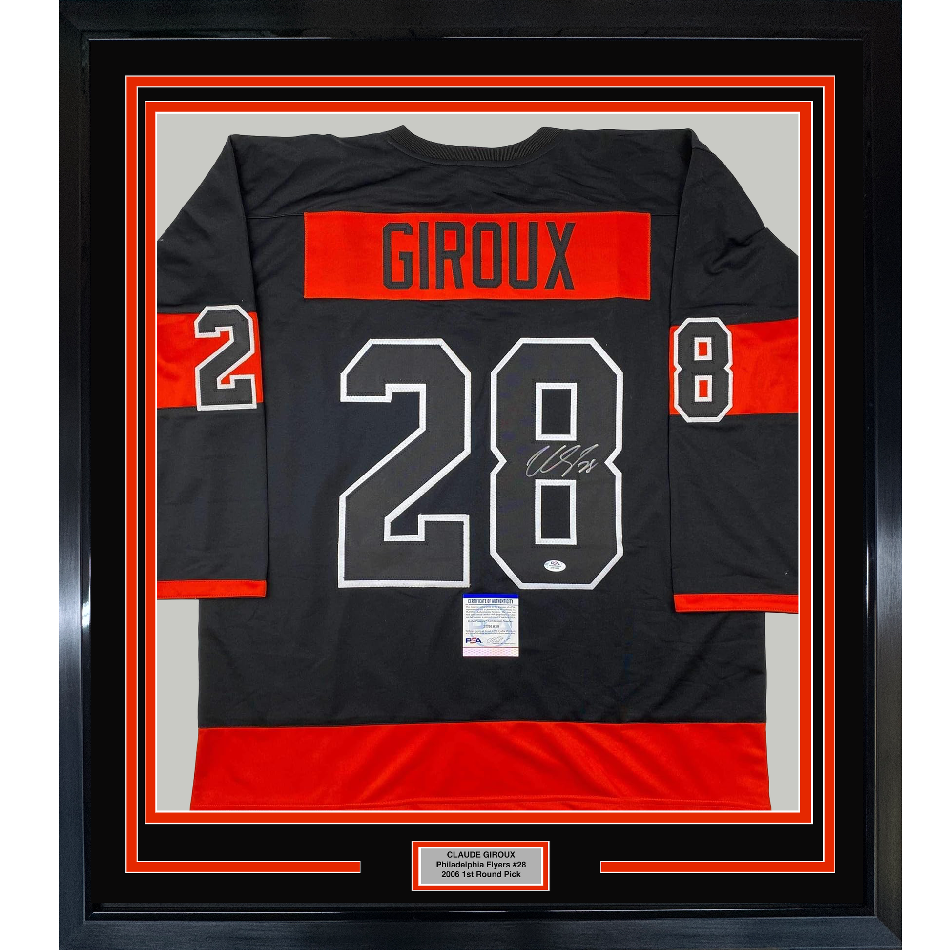 Framed black and red Philadelphia Flyers hockey jersey displaying "GIROUX 28" with signature, mounted in black frame with red borders and nameplate.