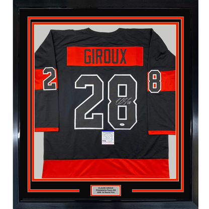 Framed black and red Philadelphia Flyers hockey jersey displaying "GIROUX 28" with signature, mounted in black frame with red borders and nameplate.