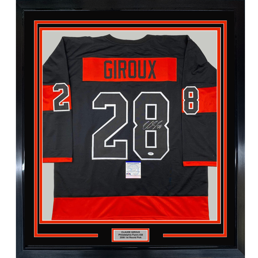Framed black and red Philadelphia Flyers hockey jersey displaying "GIROUX 28" with signature, mounted in black frame with red borders and nameplate.