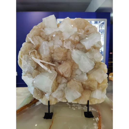 Clear apophyllite cubes with stilbite and scolecite geode on stone base