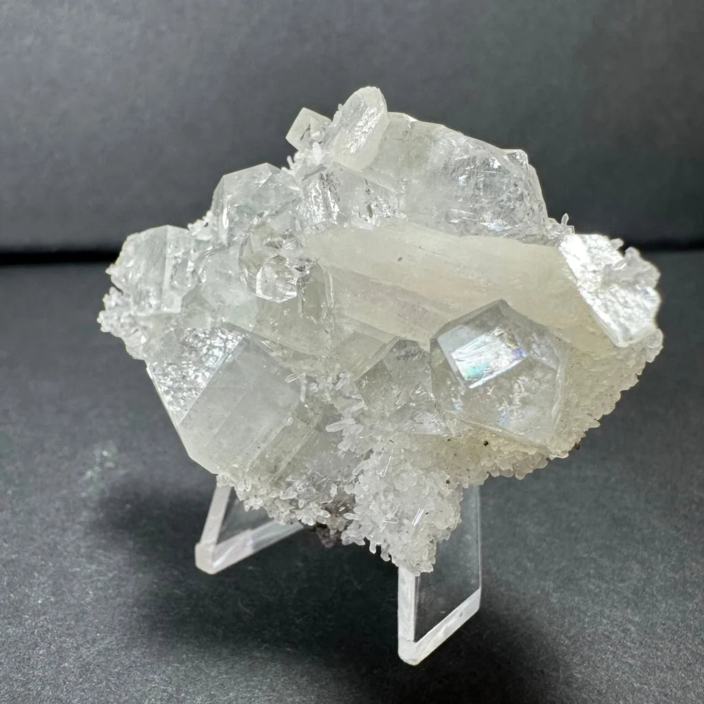 Clear apophyllite with white stilbite crystal cluster on acrylic stand