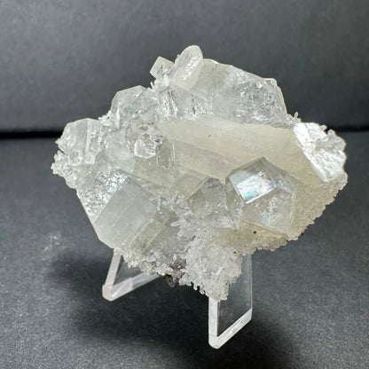 Clear apophyllite with white stilbite crystal cluster on acrylic stand