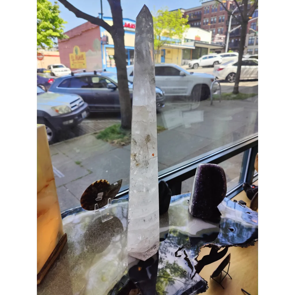 Clear quartz polished obelisk sculpture 20.5 inches tall with natural inclusions and pointed top weighing 3.35kg