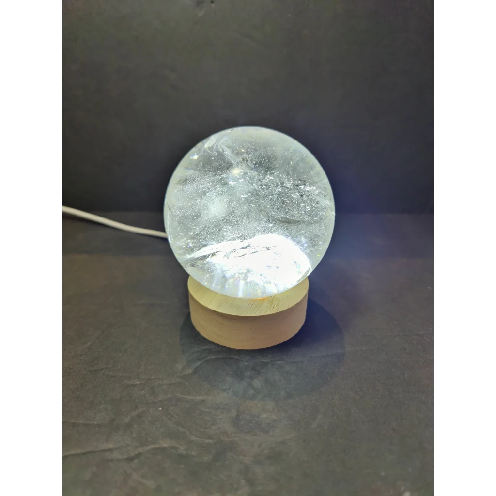Clear quartz polished sphere sculpture with clear crystal globe lamp and wooden base for decorative use