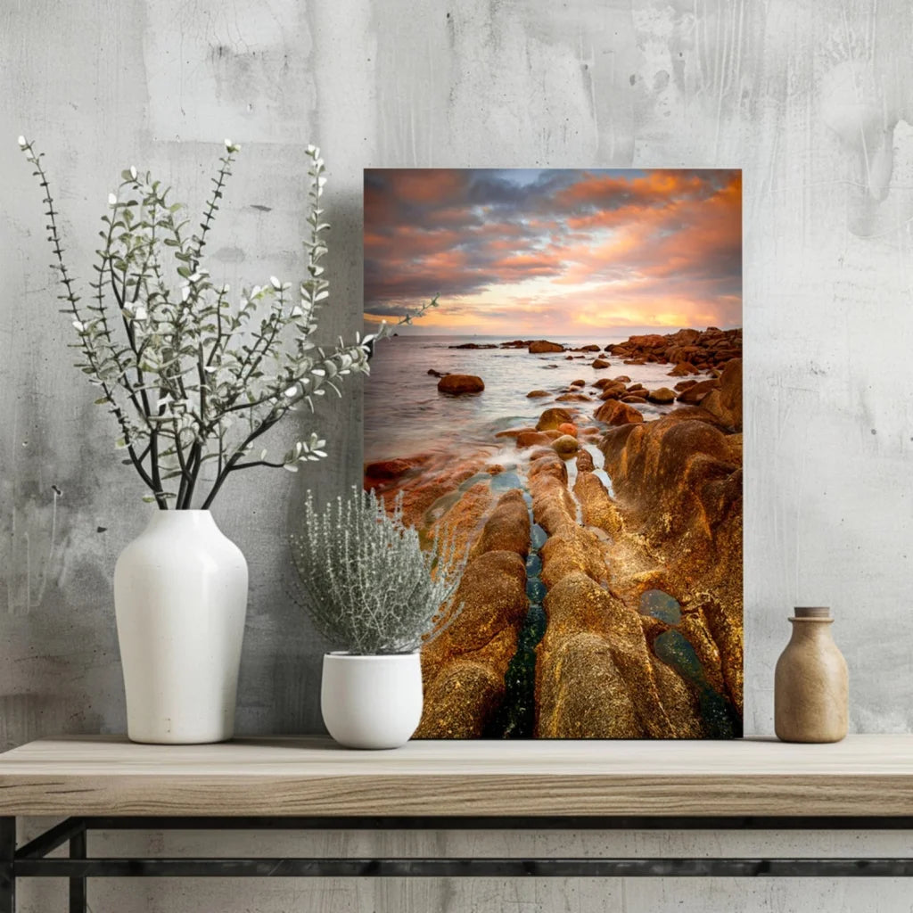 Vibrant sunset on rocky shore in Insigne aluminum prints