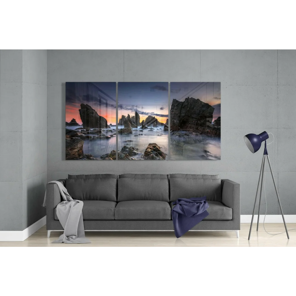Three-panel coastal sunset wall art with dramatic rocks and vibrant sky