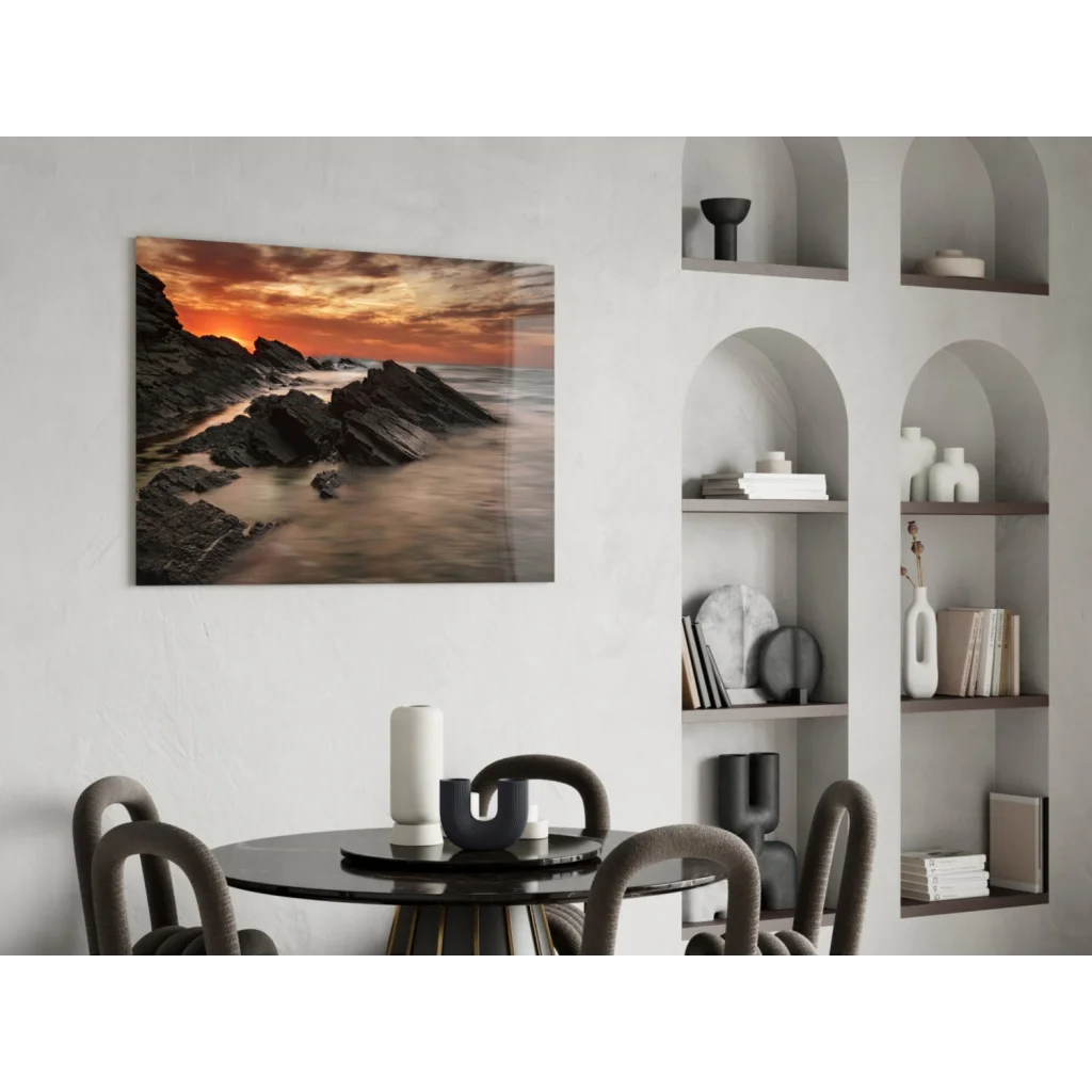 Fiery coastal sunset glass wall art over rugged rocks