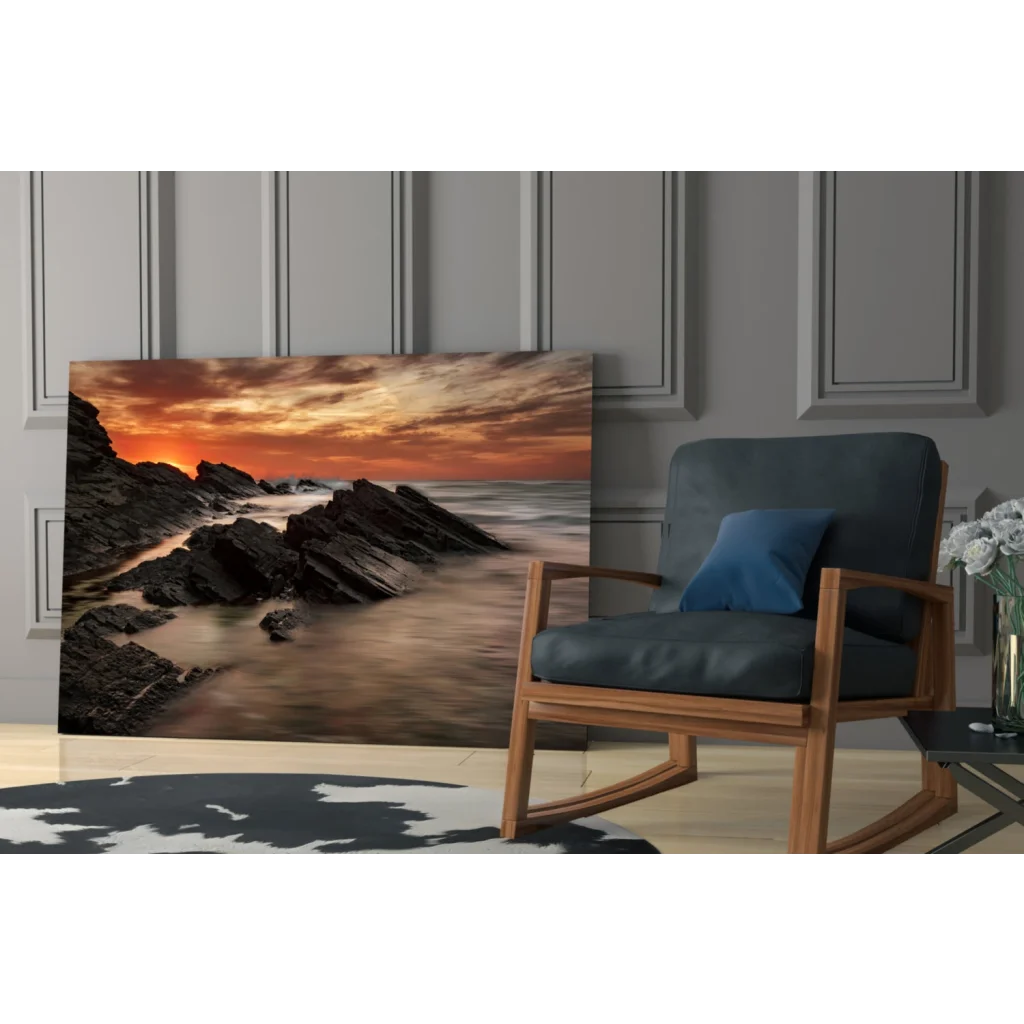 Fiery coastal sunset glass wall art over rugged rocks