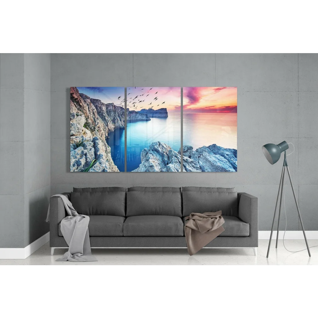 Vibrant coastal sunset glass wall art with cliffs, turquoise sea, and soaring birds