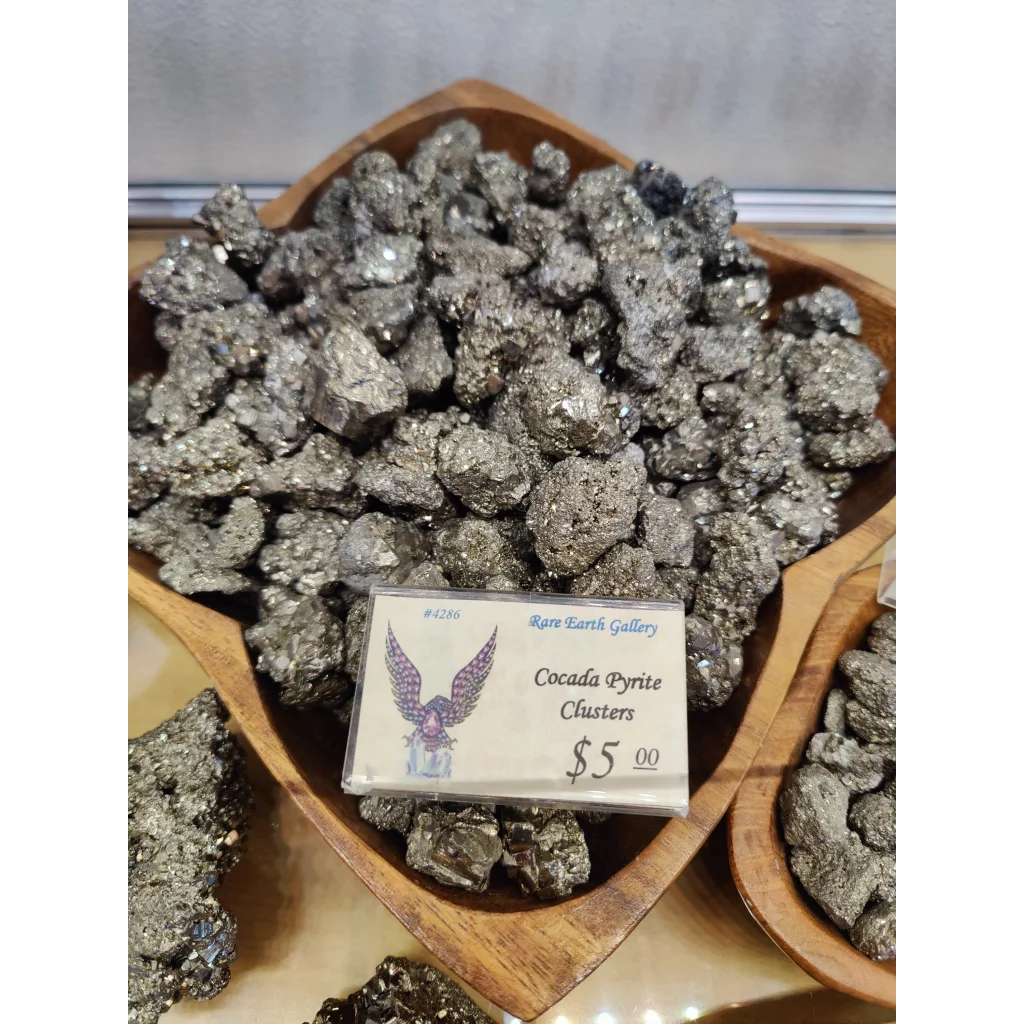 Shiny cocada pyrite cluster in wooden bowl