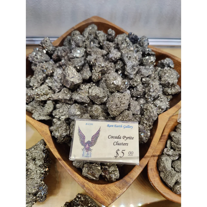 Shiny cocada pyrite cluster in wooden bowl