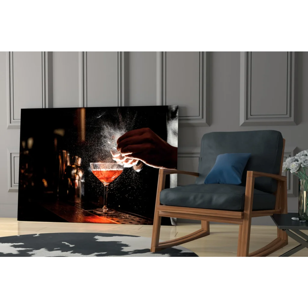 Black-framed canvas wall art of hand pouring red liquid into martini glass
